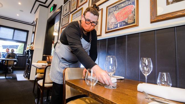 O'Connells gastropub head chef Tony Moss readies a table for diners. Picture: Jay Town