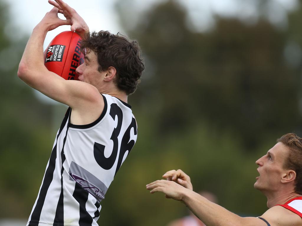 AFL Outer East: Narre Warren’s Hamish West uses his head to mark the ball against Olinda Ferny Creek. Picture: Stuart Milligan