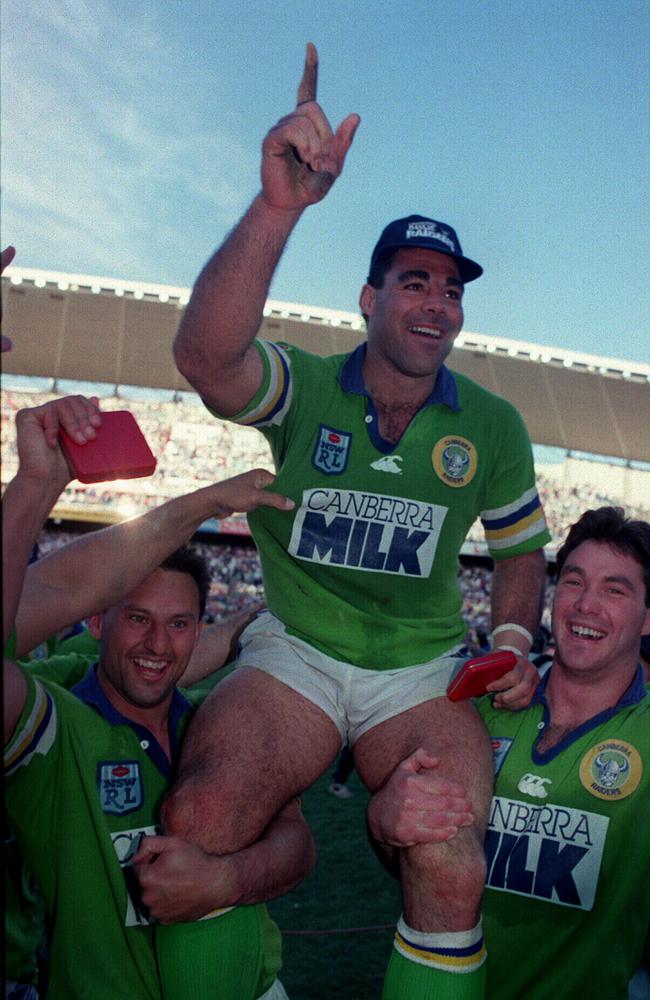 Canberra Raiders players Laurie Daley and Bradley Clyde hoist captain Mal Meninga after the Grand Final win against Canterbury in 1994.