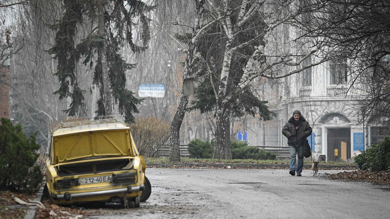 A local resident walks past a damaged car in Bakhmut, Donetsk region. Picture: AFP