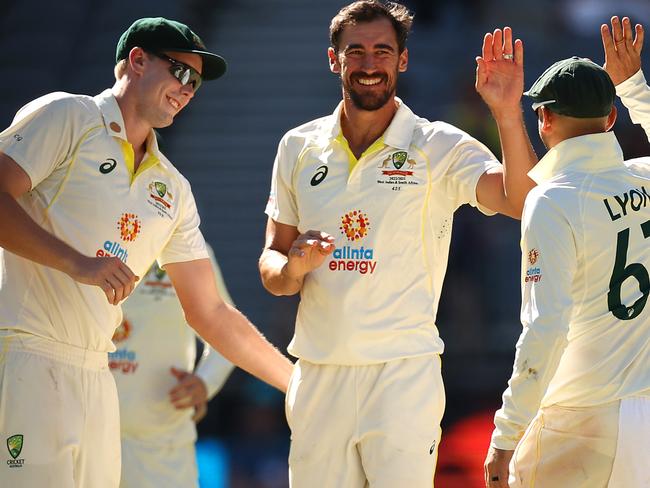 PERTH, AUSTRALIA - DECEMBER 02: Mitchell Starc of Australia celebrates with team mates after bowling out Joshua da Silva of the West Indies during day three of the First Test match between Australia and the West Indies at Optus Stadium on December 02, 2022 in Perth, Australia. (Photo by Cameron Spencer/Getty Images)