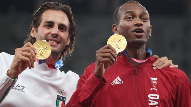 TOKYO, JAPAN - AUGUST 02: Joint gold medalists Mutaz Essa Barshim of Team Qatar and Gianmarco Tamberi of Team Italy celebrate on the podium during the medal ceremony for the Men's High Jump on day ten of the Tokyo 2020 Olympic Games at Olympic Stadium on August 02, 2021 in Tokyo, Japan. (Photo by Patrick Smith/Getty Images)