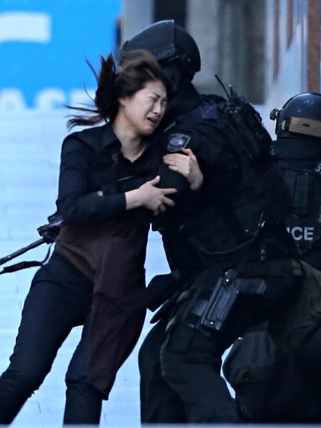 A siege hostage ran to heavily armed police as the sieged ended. Picture: Adam Taylor