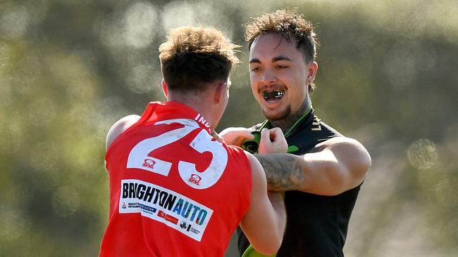 Michael Giles of East Brighton and Dylan Bowman of Doveton Doves get close and personal. (Photo by Josh Chadwick)