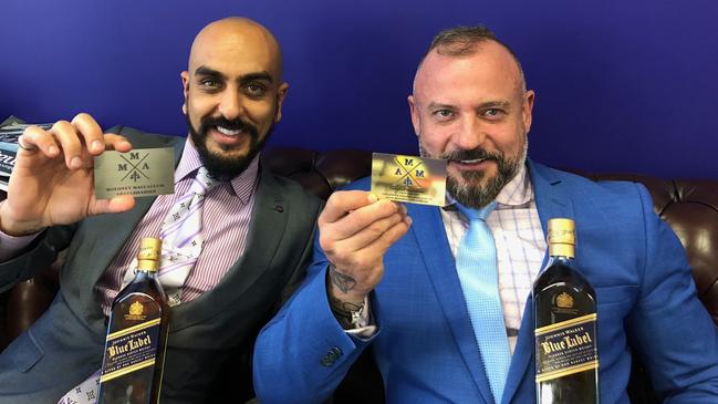 Antonious Abdelshahied (left) and Campbell MacCallum show off their business cards in happier times at Moloney MacCallum Abdelshahied Lawyers.