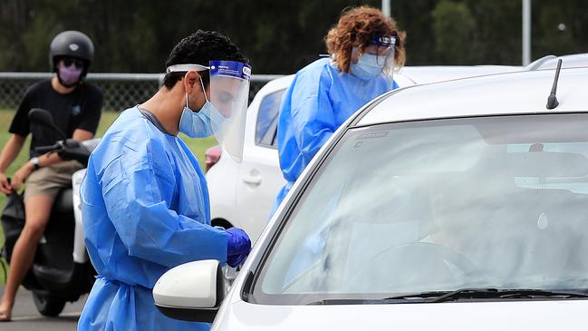 Staff test Gold Coast locals at a pop-up testing clinic in Currumbin. Picture: NCA NewsWire / Scott Powick