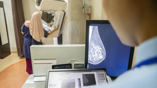 Example images of female patient receiving breast scan. iStock.