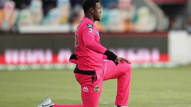 HOBART, AUSTRALIA - DECEMBER 10: Carlos Brathwaite of the Sixers takes a knee during the Big Bash League match between the Hobart Hurricanes and Sydney Sixers at Blundstone Arena, on December 10, 2020, in Hobart, Australia. (Photo by Matt King/Getty Images)