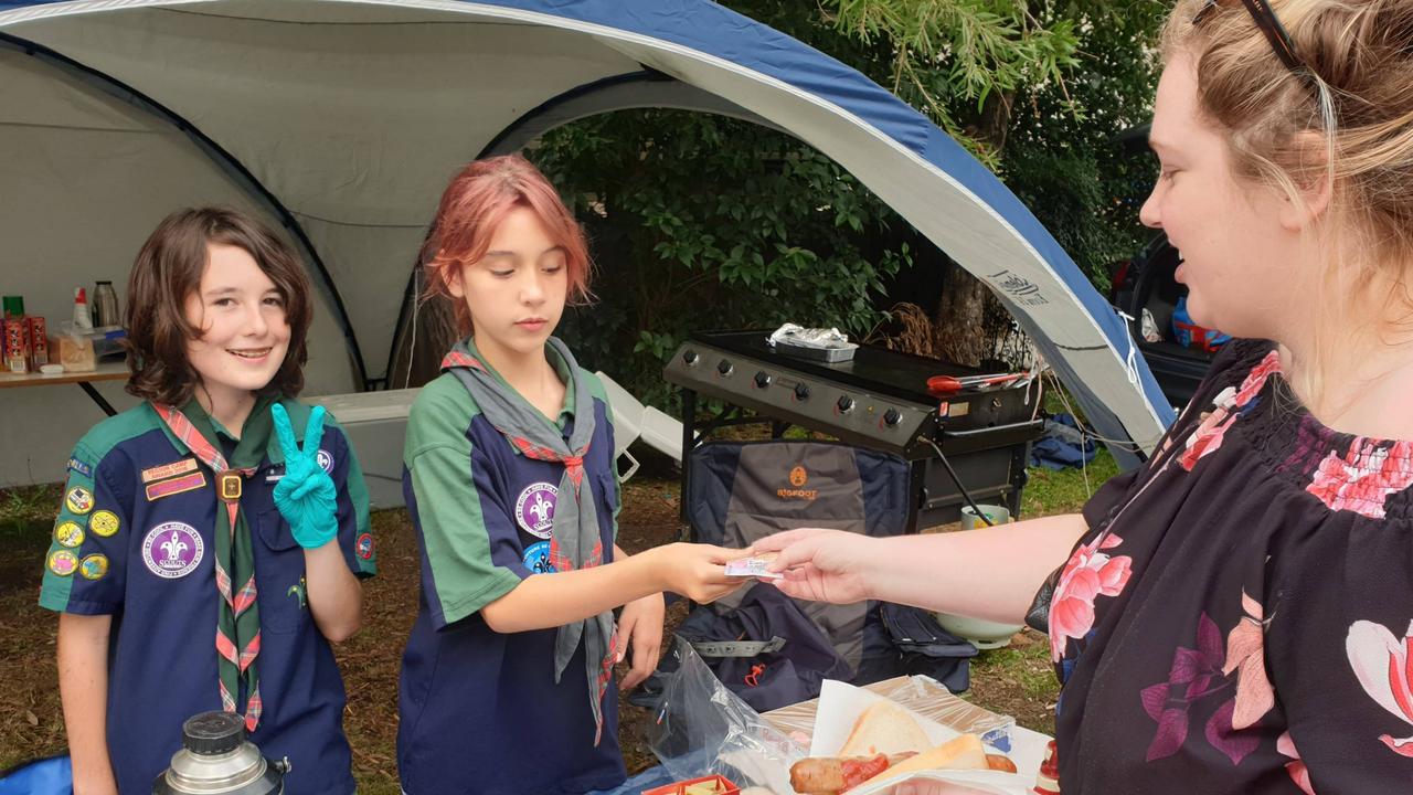 Aiden Kemp and Emily Collins help with snacks at a polling centre in the marginal electorate of East Hills. Picture: Benjamin Graham