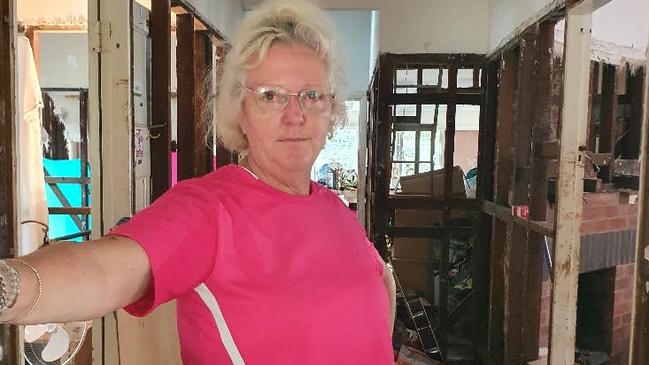 Donna Walker, with her damaged home in the background said she feels flat. Picture: supplied.