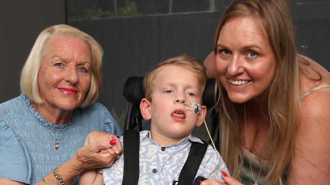 Landon Otsen with Grandma Lynne and mum Lisa. A Torquay family is celebrating after a community effort has raised more than $60,000 for the purchase a special van for their wheelchair bound boy Landon Otsen. Picture: Alan Barber