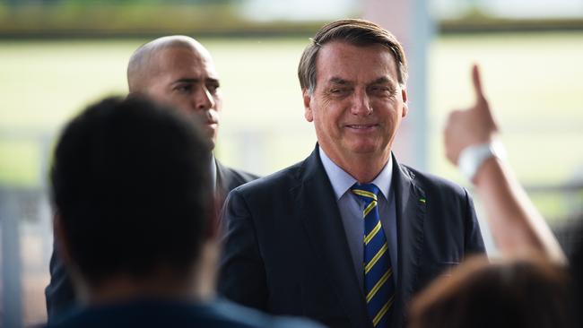 Jair Bolsonaro says social distancing measures are needlessly hurting the economy, and regularly flouts them himself, hitting the streets in Brasilia and working the crowd in close quarters at rallies by his supporters. Picture: Getty Images