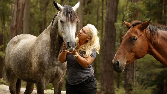 Riding school owner Natalie Skillings-Smith from Woodburn is reunited with her horses Centaur (left) and Concice that survived the floods living on Woodburn Bridge for seven days. Natalie and her husband Shane rescued most of their horses in their tinnie. Picture: Jonathan Ng