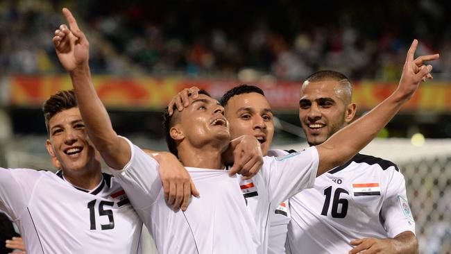 Ahmed Yaseen Gheni of Iraq (C) celebrates scoring against Palestine with teammates Waleed Salim Al­-Lami (L) Dhurgham Ismael Dawood (2nd-R) and Marwan Hussein Al-­Ajeeli (R) during their Group D football match of the AFC Asian Cup in Canberra on January 20, 2015. AFP PHOTO/Peter PARKS --IMAGE RESTRICTED TO EDITORIAL USE - STRICTLY NO COMMERCIAL USE