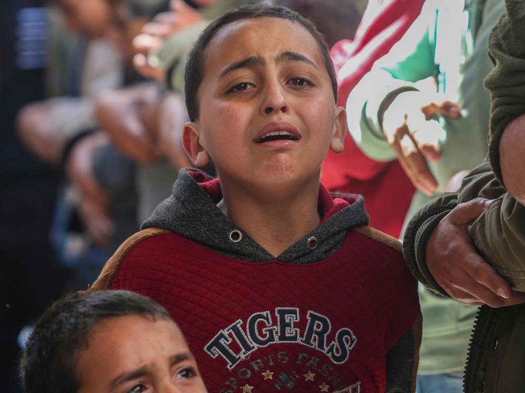 Children mourn as they receive the dead bodies of victims of an Israeli strike in Rafah, Gaza. Picture: Getty Images