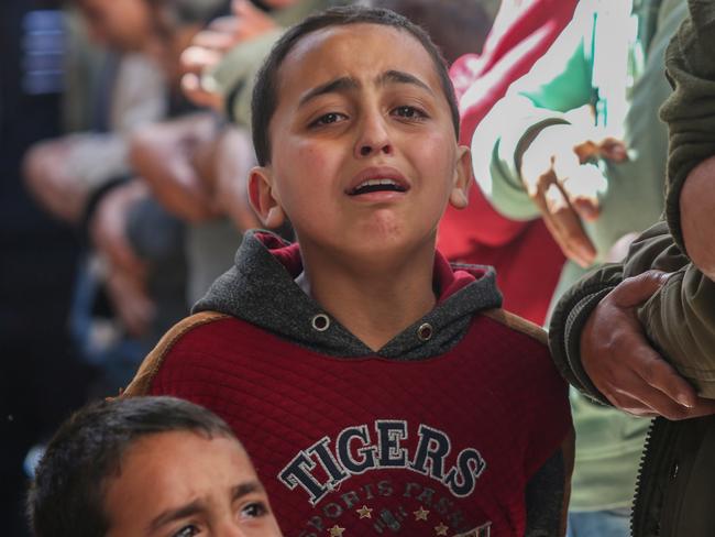 Children mourn as they receive the dead bodies of victims of an Israeli strike in Rafah, Gaza. Picture: Getty Images