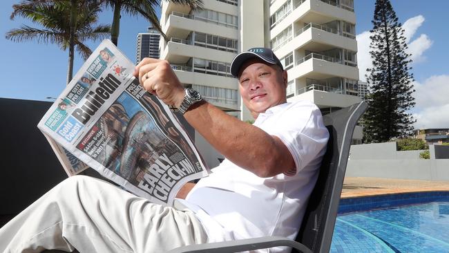 Reading his front page story in the Bulletin is Tony Fung. Picture: Richard Gosling