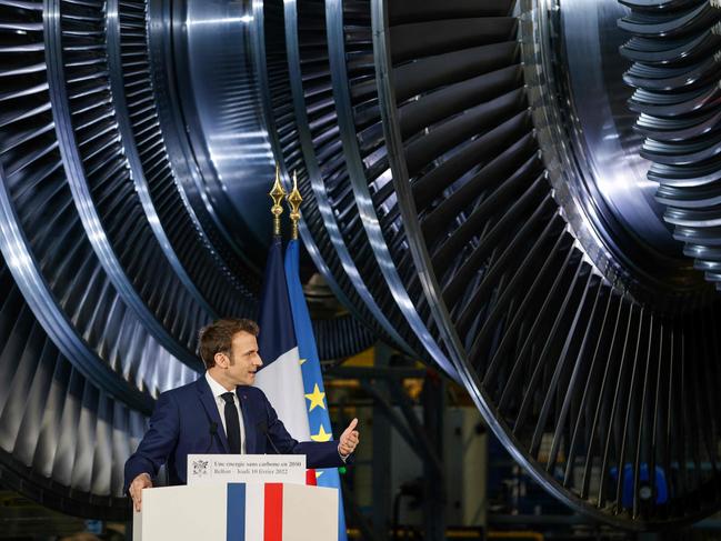 TOPSHOT - French President Emmanuel Macron delivers a speech at the GE Steam Power System main production site for its nuclear turbine systems in Belfort, eastern France, on February 10, 2022, as part of a visit dedicated to energy policy and the future of the country's atomic industry, which provides around 70 percent of French electricity. - French President Emmanuel Macron is set to throw his support behind a massive nuclear power plant programme during his visit, despite concerns about the cost and complexity of building new reactors. (Photo by Jean-Francois Badias / POOL / AFP)