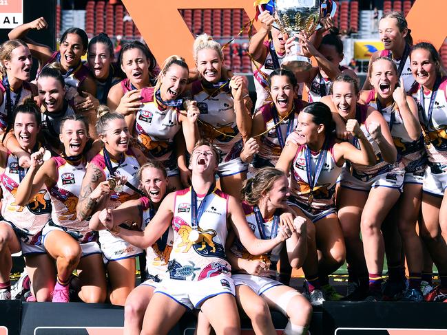 Brisbane Lions players celebrate after receiving the premiership cup. Picture: Getty Images