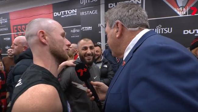 Kamil Yucel in the Essendon rooms with Nick Hind. Photo: Channel 7.