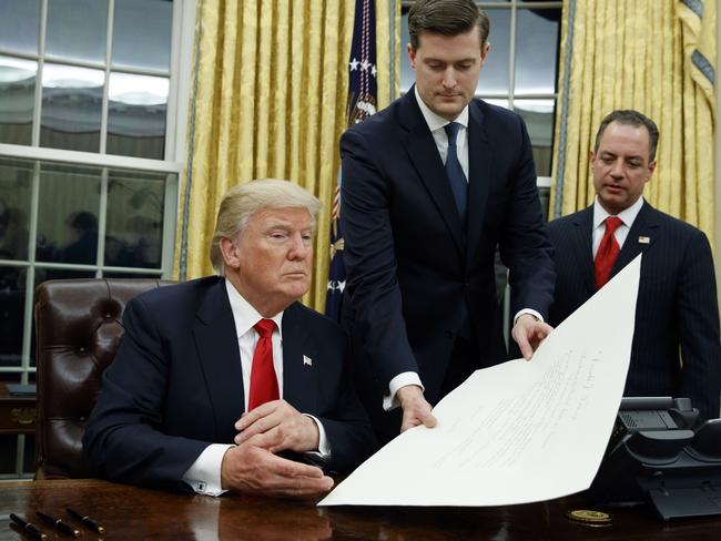 Former White House staff secretary Rob Porter, centre, with US President Donald Trump. Picture: AP