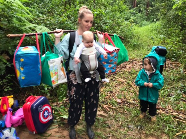 Lauren Archer trekking with here children to safety through the rain forest in Upper Lansdowne.