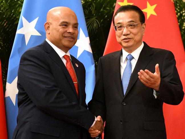 (FILES) This file photo taken on December 13, 2019 shows Micronesia's President David Panuelo (L) with China's Premier Li Keqiang at the Great Hall of the People in Beijing. - Panuelo has accused China of bribery, harassment and "political warfare", in an explosive letter to his country's legislature obtained by AFP on March 10, 2023. (Photo by Noel CELIS / POOL / AFP)