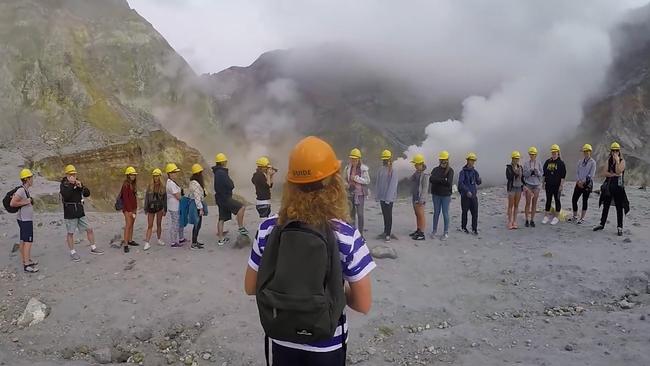 Tourists with no protective gear other than hardhats during a tour into the White Island volcano last year. Picture: Youtube