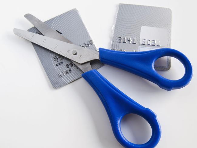 Debt and finance.  Scissors and credit card cut in half.