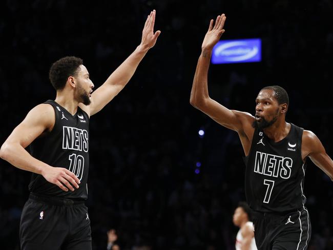 NEW YORK, NEW YORK - OCTOBER 21: Ben Simmons #10 celebrates with Kevin Durant #7 of the Brooklyn Nets during the second half against the Toronto Raptors at Barclays Center on October 21, 2022 in the Brooklyn borough of New York City. The Nets won 109-105. NOTE TO USER: User expressly acknowledges and agrees that, by downloading and or using this photograph, User is consenting to the terms and conditions of the Getty Images License Agreement. (Photo by Sarah Stier/Getty Images)