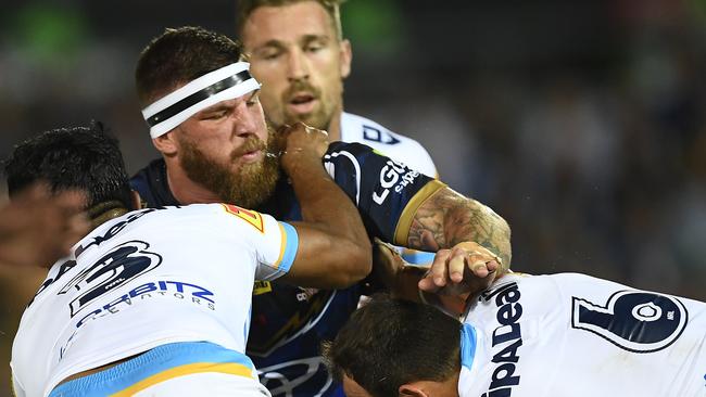 TOWNSVILLE, AUSTRALIA - MAY 03: Josh McGuire of the Cowboys is tackled by Tyrone Roberts and Tyrone Peachey of the Titans during the round eight NRL match between the North Queensland Cowboys and the Gold Coast Titans at 1300SMILES Stadium on May 03, 2019 in Townsville, Australia. (Photo by Ian Hitchcock/Getty Images)