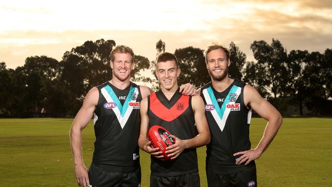 Former Rostrevor students, now Port Adelaide players Tom Jonas (left) and Jack Hombsch (right) with the college’s SA under-18 captain Luke Valente. Picture: Dylan Coker.