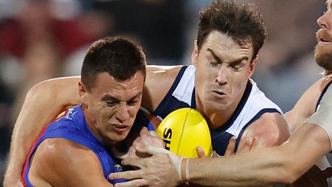 GEELONG, AUSTRALIA - APRIL 08: Hugh McCluggage of the Lions is tackled by Jeremy Cameron and Cameron Guthrie of the Cats (right) during the 2022 AFL Round 04 match between the Geelong Cats and the Brisbane Lions at GMHBA Stadium on April 08, 2022 In Geelong, Australia. (Photo by Michael Willson/AFL Photos via Getty Images)