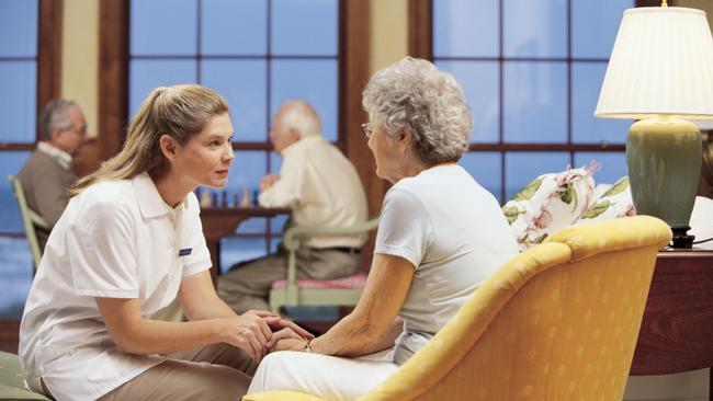 Generic pic of a nurse talking to a woman in a nursing home.