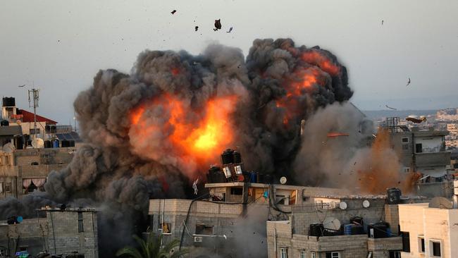 A ball of fire erupts from a building in Gaza City's Rimal residential district during massive Israeli bombardment on the Hamas-controlled enclave.