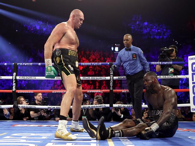 Tyson Fury stands over Deontay Wilder in their second fight. Picture: Al Bello/Getty