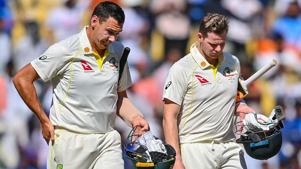 Scott Boland and teammate Steve Smith walk off the ground after India's win in the first Test. Picture: AFP