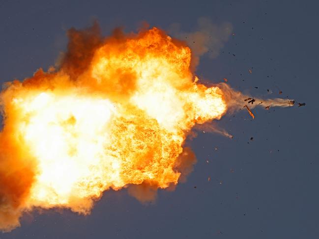 TOPSHOT - This photo taken from a position in northern Israel shows a Hezbollah UAV intercepted by Israeli air forces over north Israel on August 25, 2024. The Israeli military announced early August 25, 2024 that it was conducting pre-emptive strikes in Lebanon after detecting preparations for "large-scale" attacks by the Iran-backed militant group Hezbollah. Hezbollah said August 25, 2024 it had launched more than 320 rockets at Israel overnight, targeting a string of military positions, even as Israel's military said it was carrying out pre-emptive strikes against the group. (Photo by Jalaa MAREY / AFP)