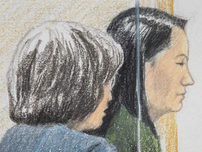 In this courtroom sketch, Meng Wanzhou, right, the chief financial officer of Huawei Technologies, sits beside a translator during a bail hearing at British Columbia Supreme Court in Vancouver, on Friday, Dec.  7, 2018.  Meng faces extradition to the U.S. on charges of trying to evade U.S. sanctions on Iran. She appeared in a Vancouver court Friday to seek bail.  (Jane Wolsak/The Canadian Press via AP)