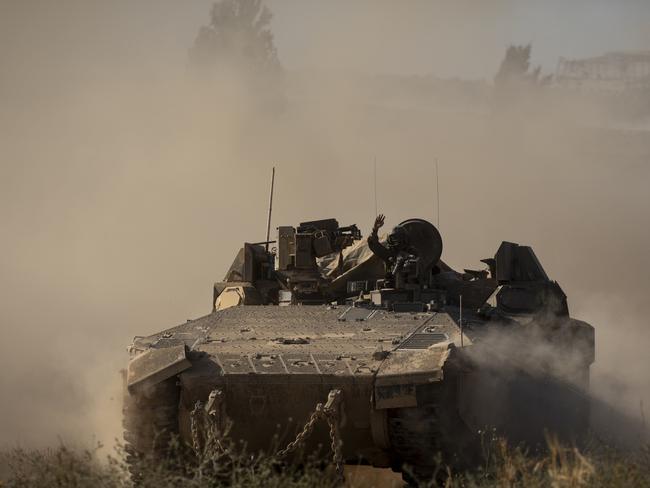 An Israeli armored personnel carrier moves a long the border after leaving the Gaza Strip. Picture: Getty Images