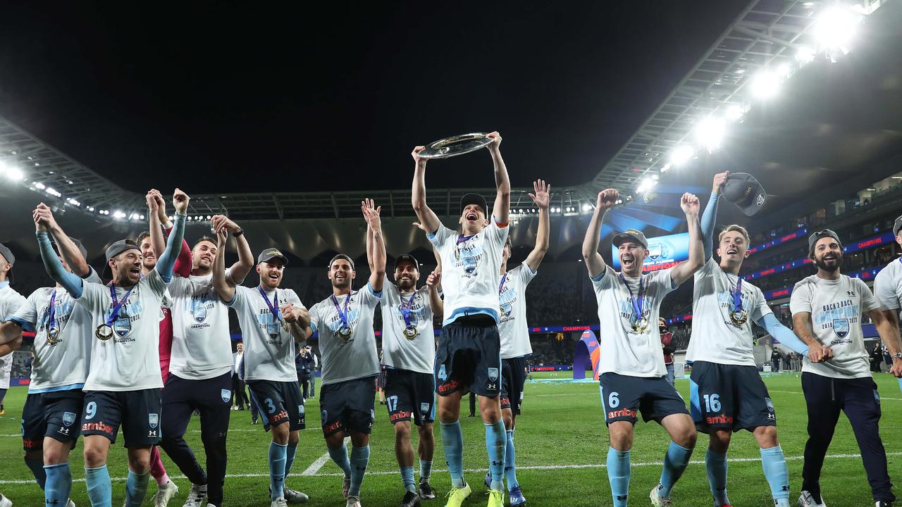 Alex Wilkinson (centre) and his Sydney FC teammates celebrate winning the A-League grand final. Picture: Brett Costello