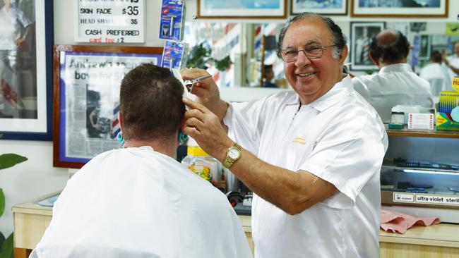 Andrew Stylianou, 76, of Andrew's Barber on Grafton Street has marked 60 year's of cutting men's hair and beards. Picture: Brendan Radke