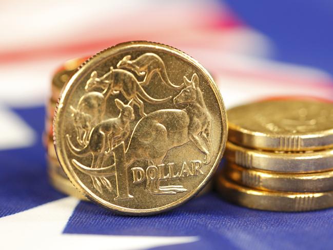 Australian coins sitting on an Australian flag. money coins dollars generic