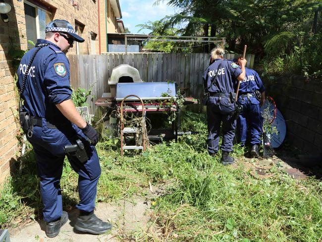 Police search the Mitchell Drive property at Bateau Bay.