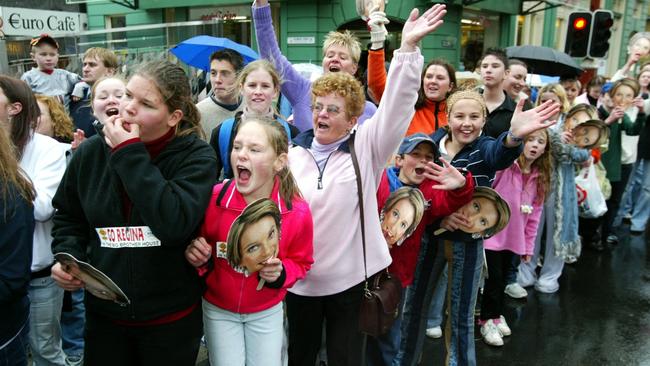 Reggie’s fans holding face masks of the Big Brother star line the streets of Hobart to welcome her home as she was driven around the city on the back of a tow truck.