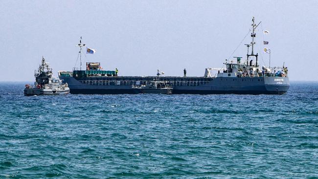 A Cyprus Coast Guard patrol boat approaches the Guinea-Bissau-flagged cargo ship Jennifer, carrying food aid provided by US charity World Central Kitchen bound for the Gaza Strip in March. Picture: Hasan Mroue/AFP