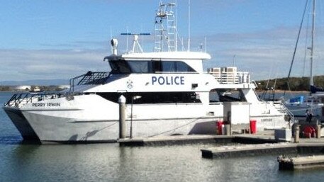 Local men helped back to dry land on board Cairns Water Police vessel, Perry Irwin MV.