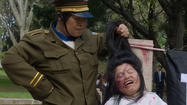 A graphic anti-persecution protest by Falun Gong practitioners during an APEC summit in Sydney, Australia.