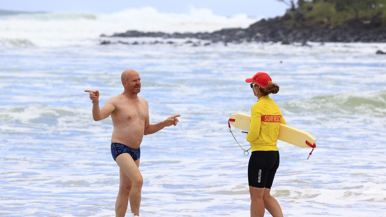 A swimmer at Burleigh Beach on the Gold Coast is advised to leave the water by Lifeguards Picture: Adam Head