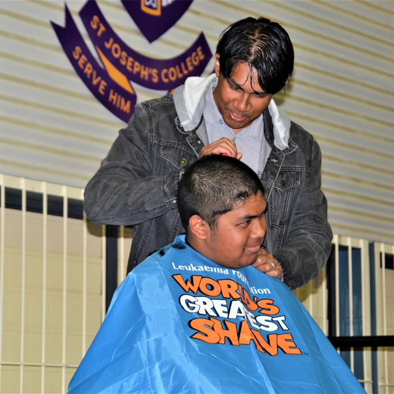 At the St Joseph's College 2023 World's Greatest Shave event is student Johann Ferrer getting his hair cut by his older brother Jeffrey Ferrer. Picture: Rhylea Millar